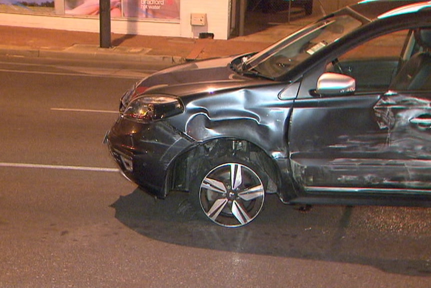 A stolen car with a shredded wheel after hitting road spikes.