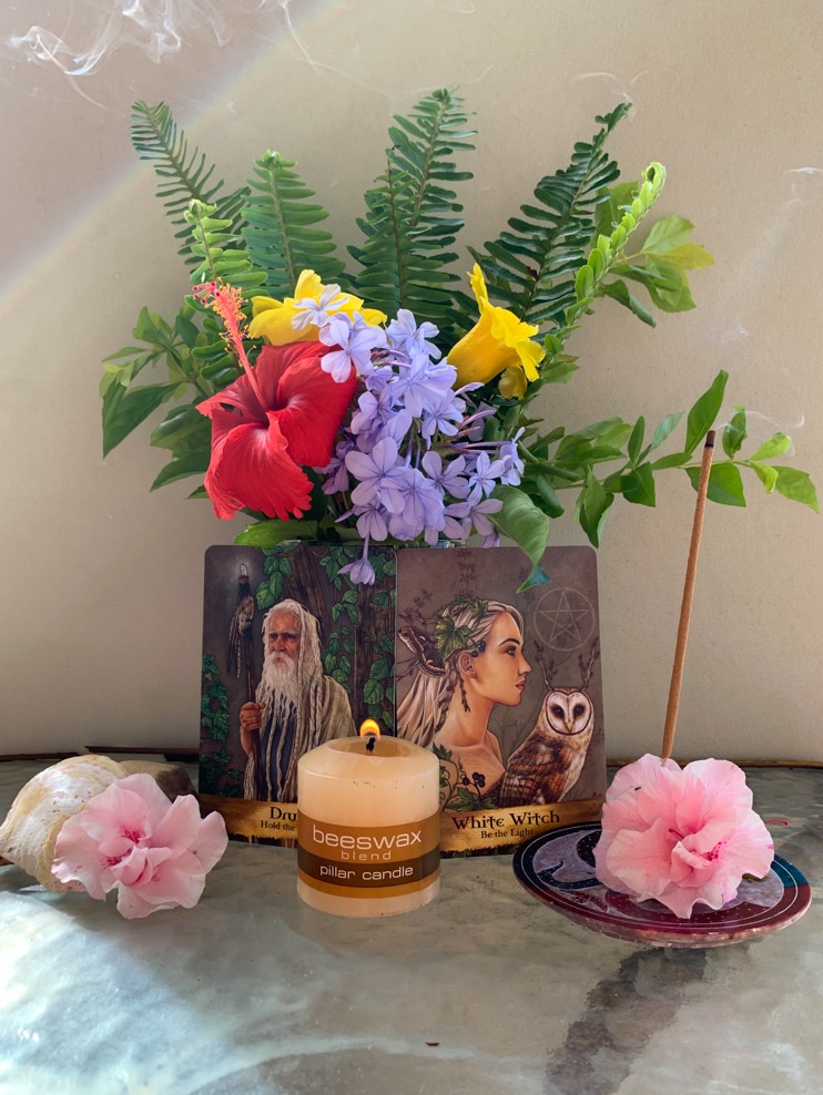 Small altar with flowers candles and incense