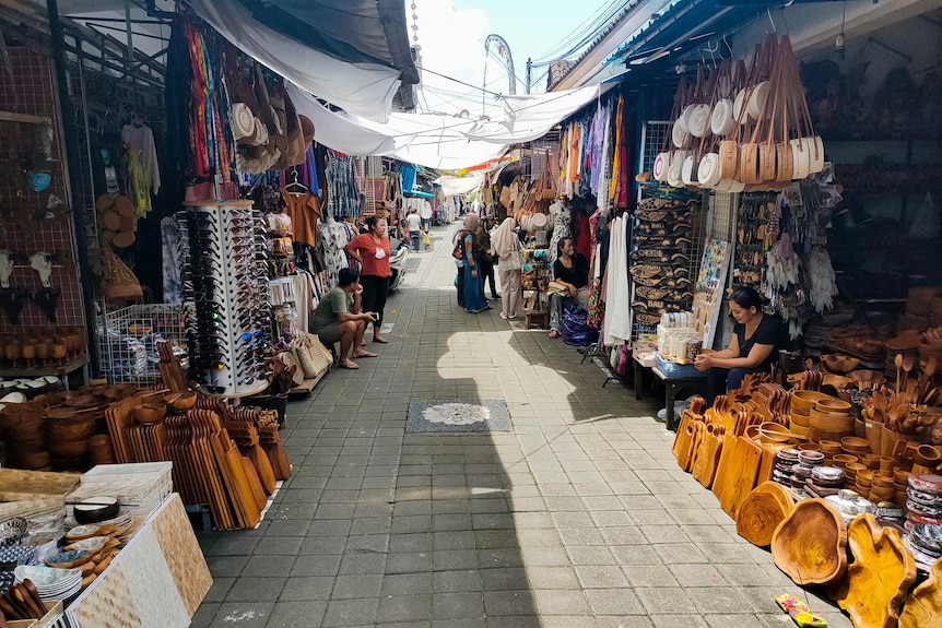 A narrow market street with stalls on either side