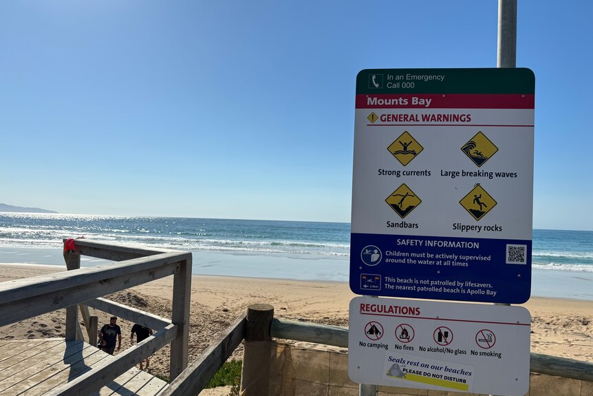 photo of a beach and safety sign