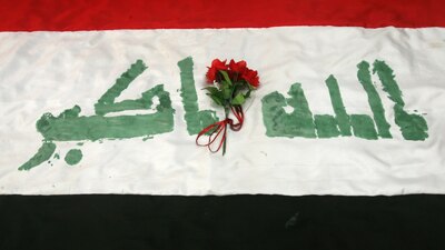Flowers on an Iraqi flag during a celebration for the U.S withdrawal, Baghdad, June 30 (Getty Images: Muhannad Fala'ah)
