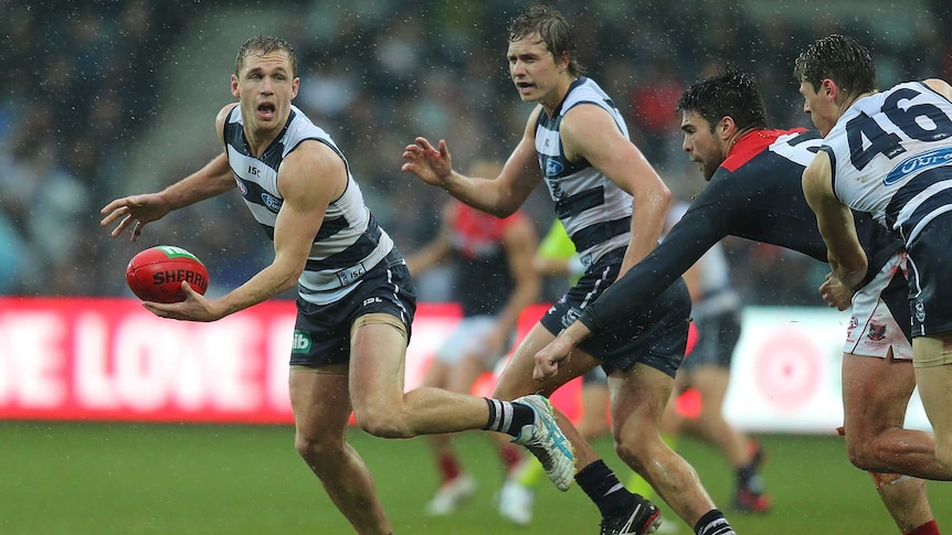 Possession game ... Joel Selwood looks for a disposal against the Demons