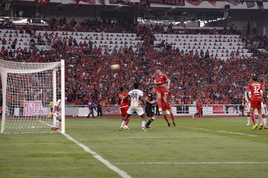 Marko Simic heads a high ball into the goal.