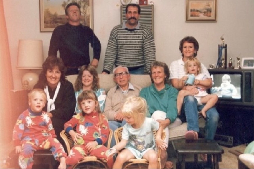 An old family photo with a group of smiling people