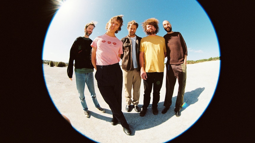 Five people standing up in a fish eye lens