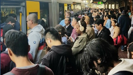 dozens of people on a train platform