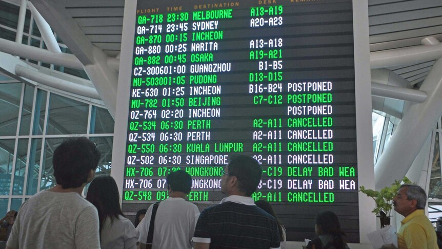 International passengers wait for postponed flights at Denpasar International Airport