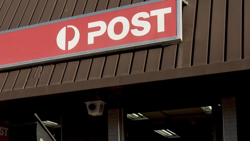 A man walks into the Australian Post post office