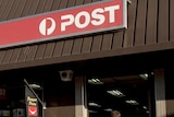 A man walks into the Australian Post post office