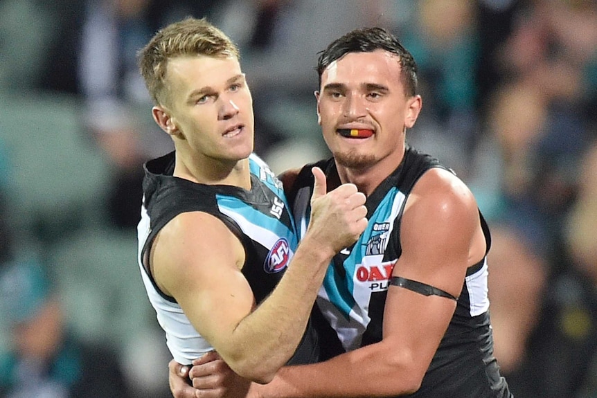 Robbie Gray and Sam Powell-Pepper have a hug.