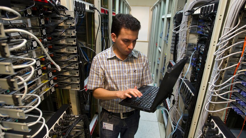 A computer engineer checks equipment at an internet service provider in Iran's capital, Tehran.
