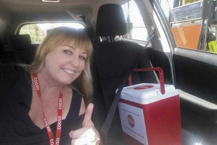 A woman takes a selfie with the ABC Radio Darwin esky.