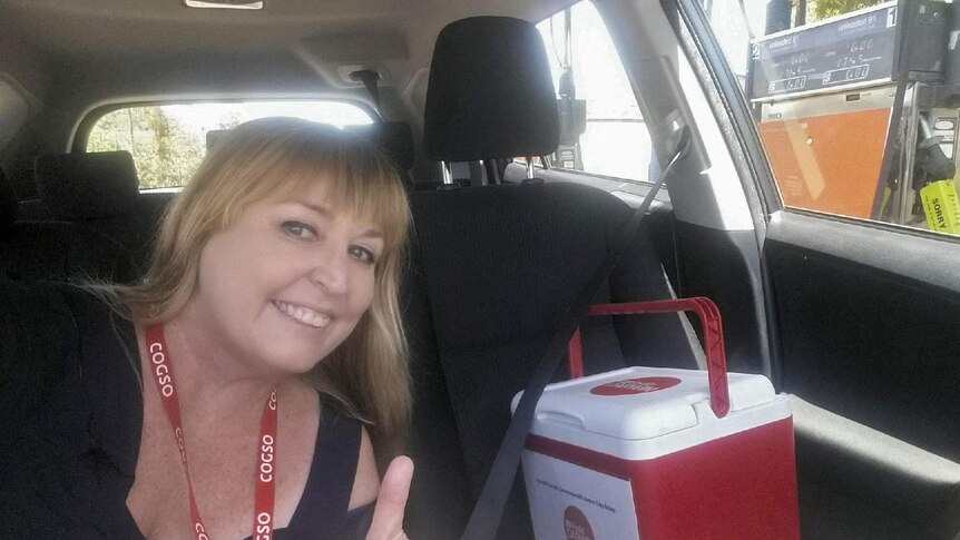 A woman takes a selfie with the ABC Radio Darwin esky.