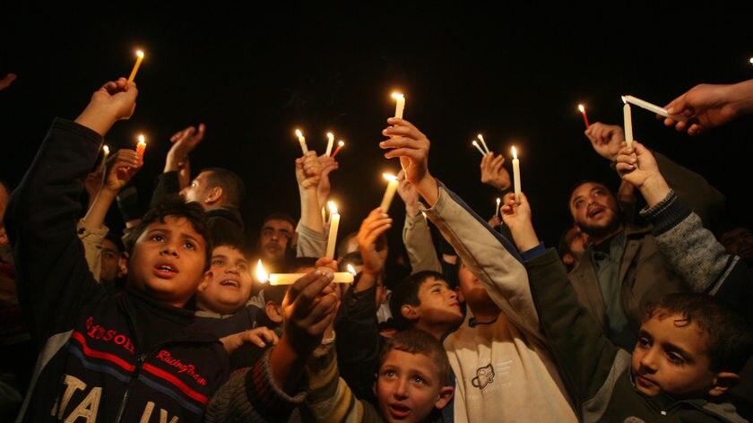 Palestinian kids with candles during protest