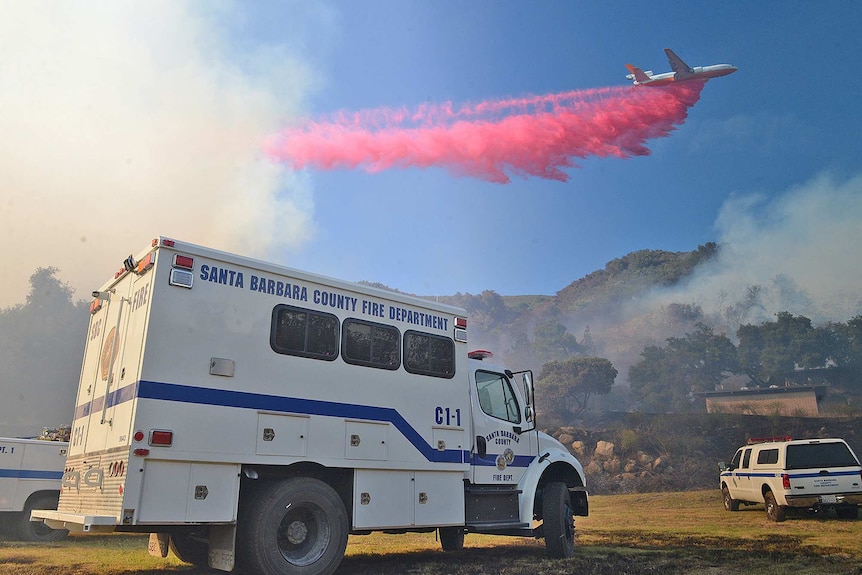 A DC-10 aircraft drops fire retardant in the hills above Santa Barbara.