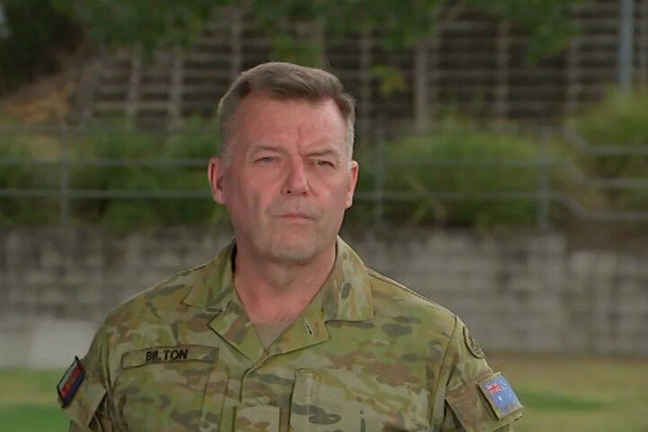 ADF Lieutenant General Greg Bilton in front of microphones discussing the recovery operations of the MRH-90 Taipan helicopter 