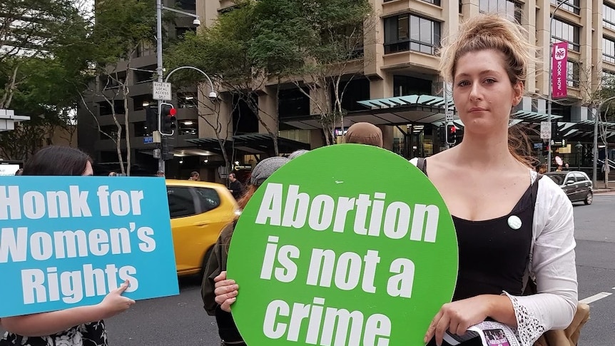 Sybil Irvin with a sign 'Abortion is not a crime' at a pro choice rally in Brisbane city on June 26, 2018.