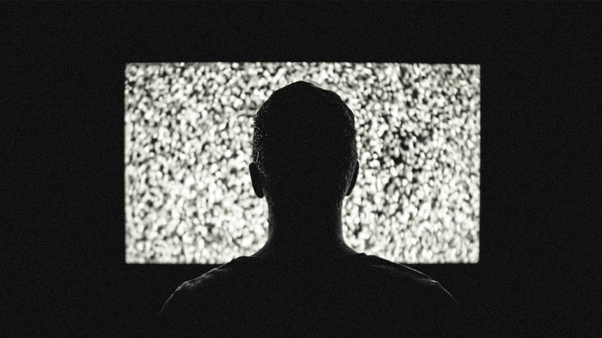 A man watches television.