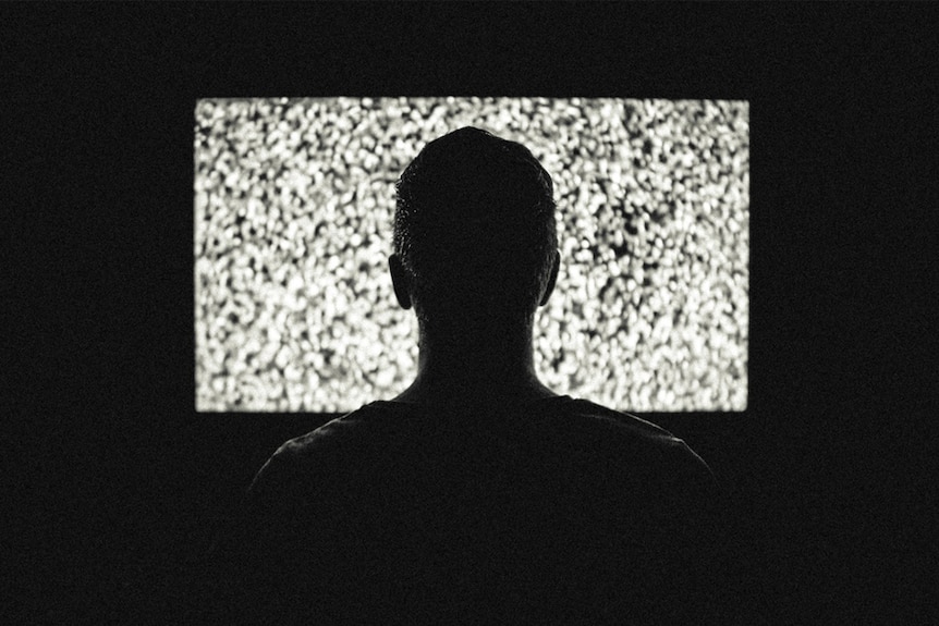 A man watches television.