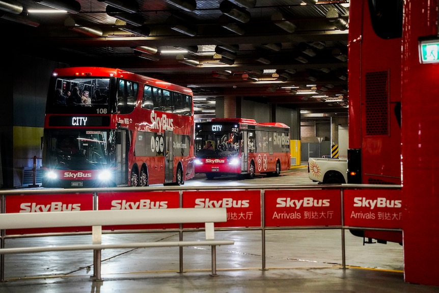 Photos of two skybuses idling at Southern Cross station