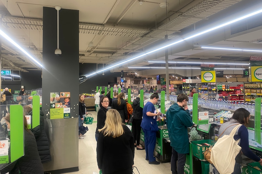 Shoppers fill the checkouts at Woolworths