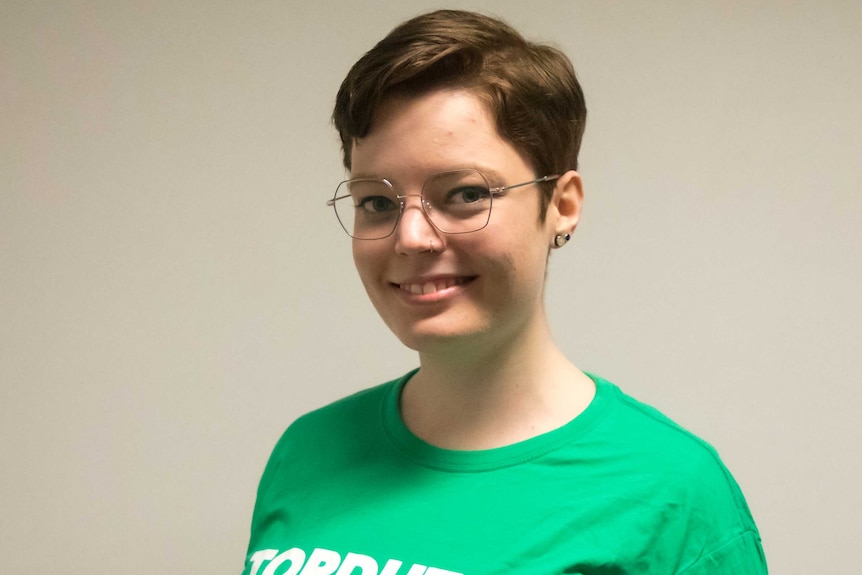 Posed shot of woman wearing green 'TopDutch solar team" T-shirt.