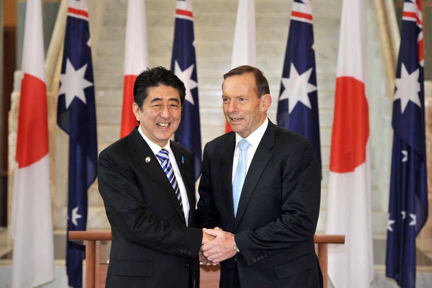 LtoR Japanese Prime Minister Shinzo Abe shakes hands with Prime Minister Tony Abbott during Canberra visit.