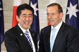 LtoR Japanese Prime Minister Shinzo Abe shakes hands with Prime Minister Tony Abbott during Canberra visit.