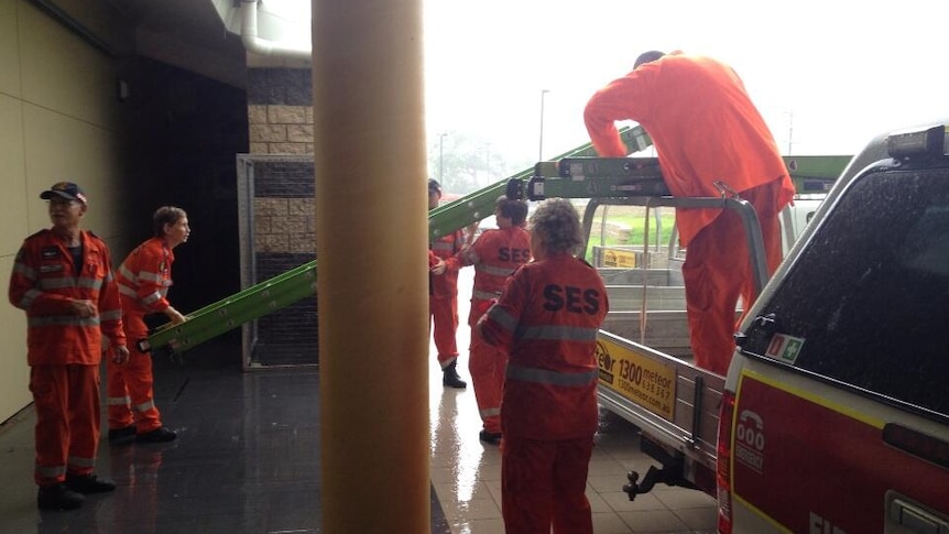 SES workers secure ladders as the wind picks up in Cooktown