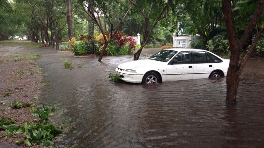 Floodwaters surround a car in Port Douglas