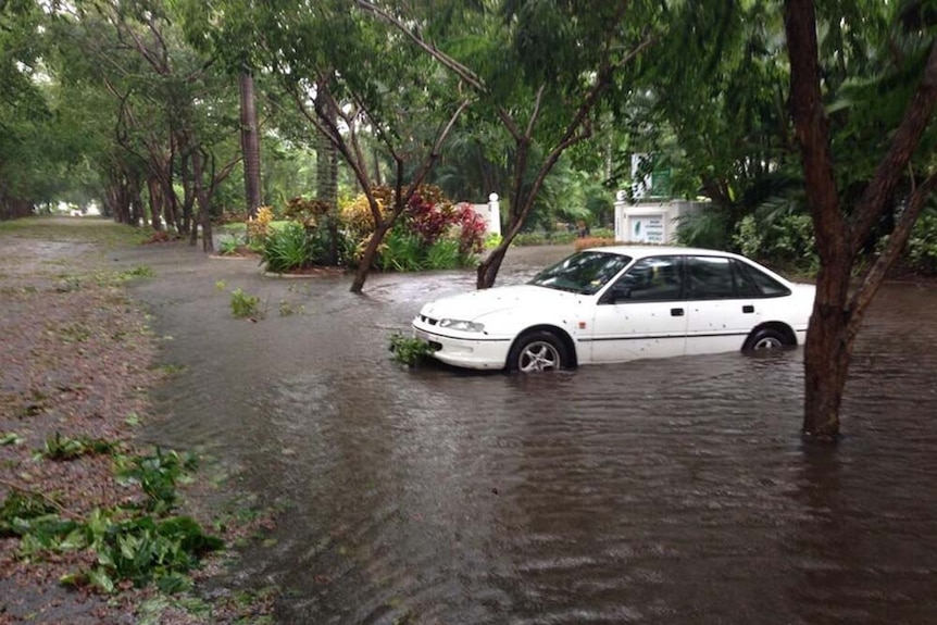 Floodwaters surround a car in Port Douglas