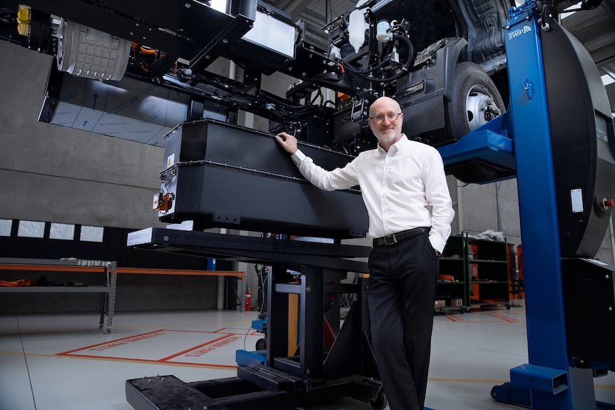 SEA Electric's Asia Pacific vice president Glen Walker under a truck being assembled.
