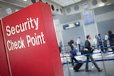 A sign directs travellers to a security checkpoint staffed by Transportation Security Administration