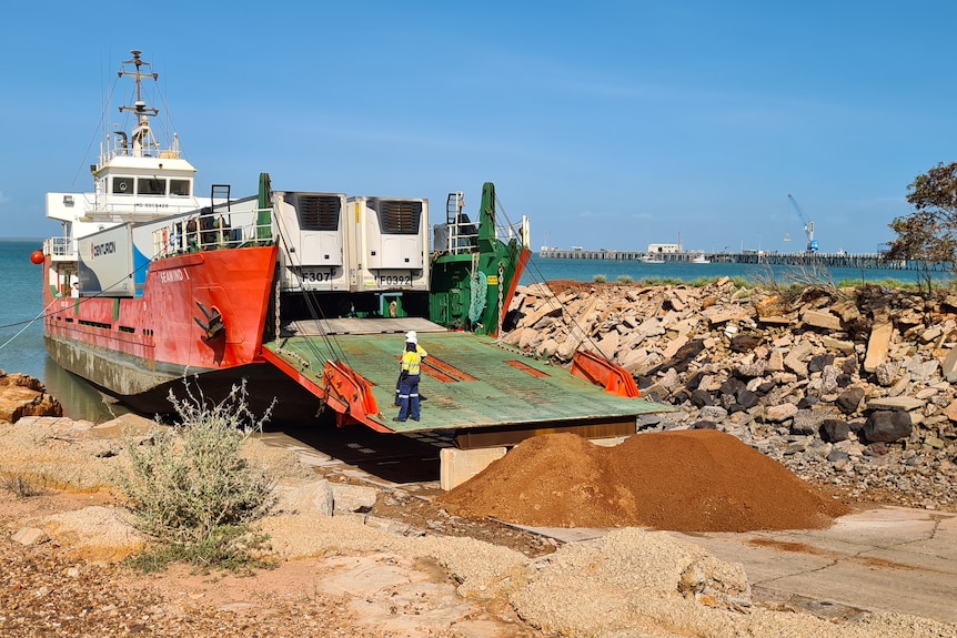 A barge prepares to unload its cargo at a port. 