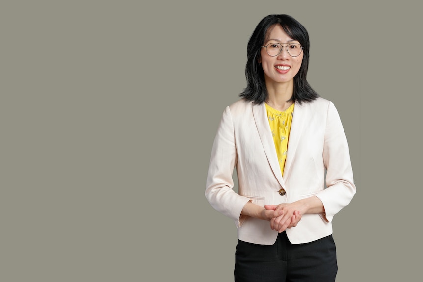 A woman standing and smiling to camera