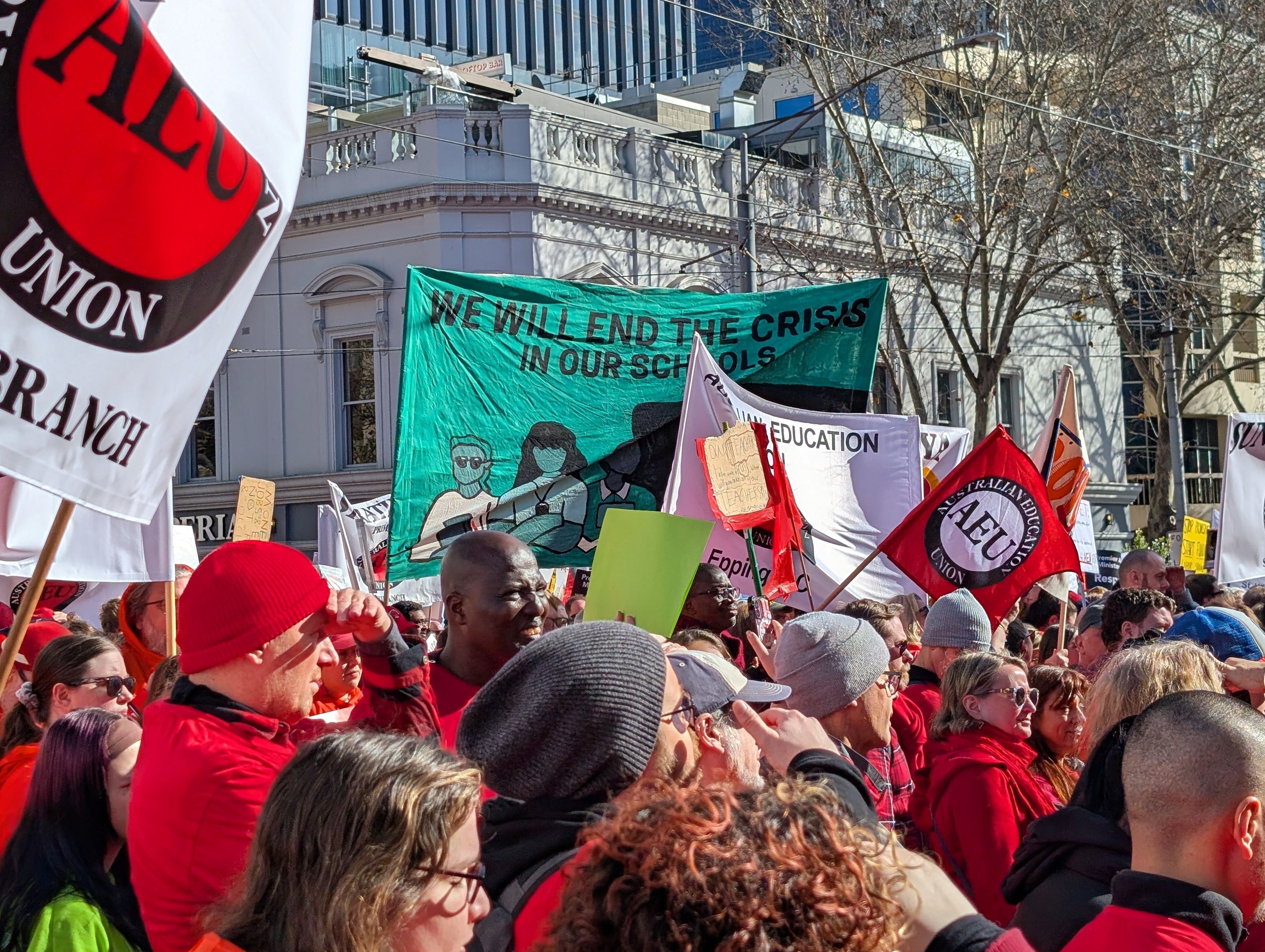 Bright banners and signs in a crowd of people.