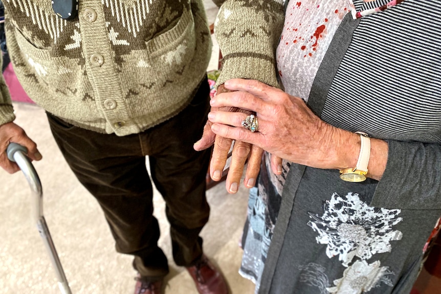 the hands of older man and woman, showing wedding rings