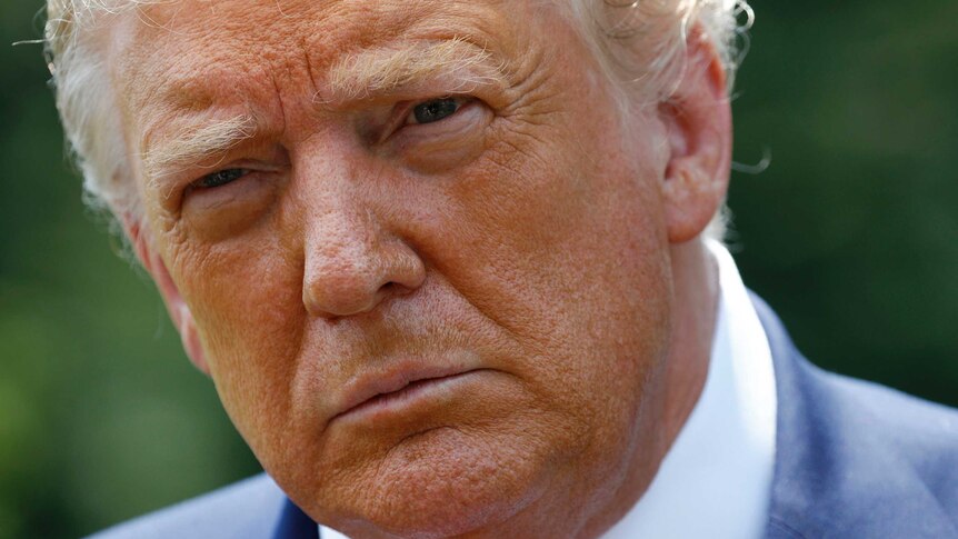 A close up of Donald Trump looking serious