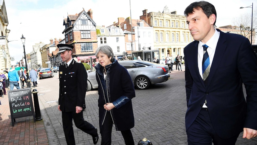 Theresa May, accompanied by police, visits the site where the Skripal's were found critically ill