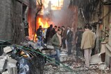 Syrian men inspect the scene of a car bomb explosion in Jaramana, a suburb of Damascus.