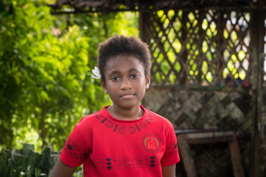 A nine-year-old Fijian girl with a thoughtful expression.