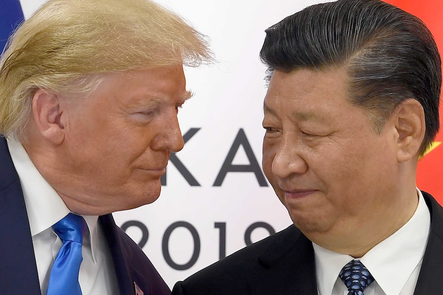 A close up shot of Donald Trump looking at Xi Jinping at the G20 summit in Japan, on June 29, 2019.