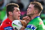 A Canberra Raiders NRL player tackles a St George Illawarra opponent.