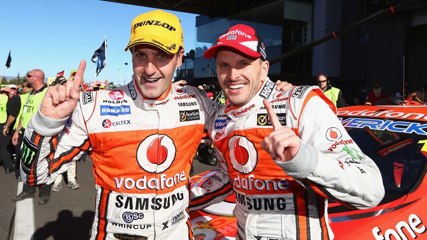 Winners are grinners ... Jamie Whincup (L) and Paul Dumbrell celebrate after their victory