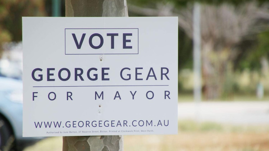 A corflute election sign for George Gear nailed to a tree.