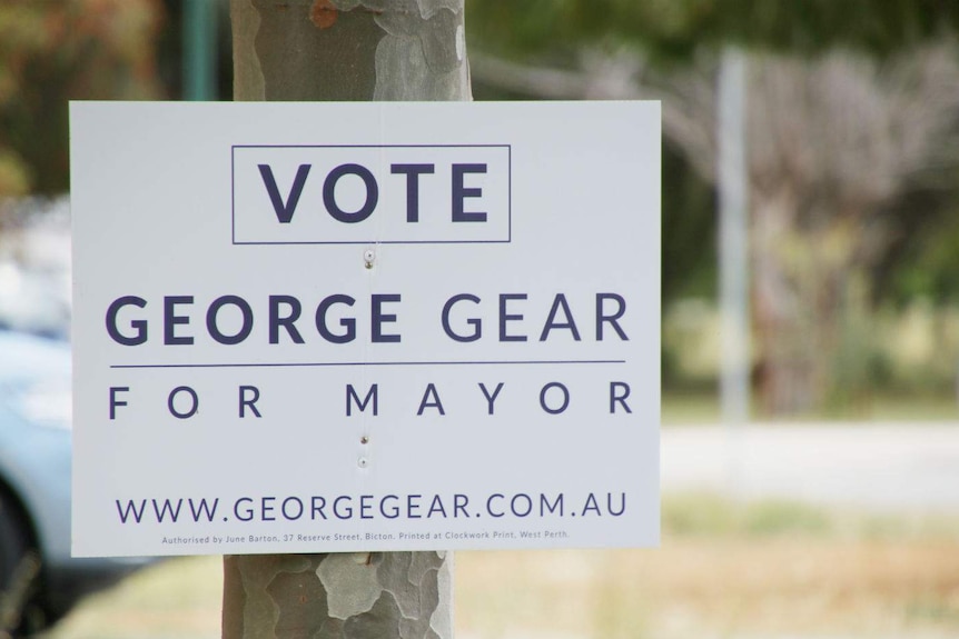 A corflute election sign for George Gear nailed to a tree.