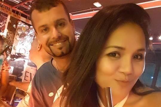 Luke Joshua Cook and Kanyarat Wechapitak pose for a selfie in a bar.