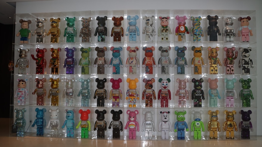 A wall-mounted collection of 60 Bearbricks. 
