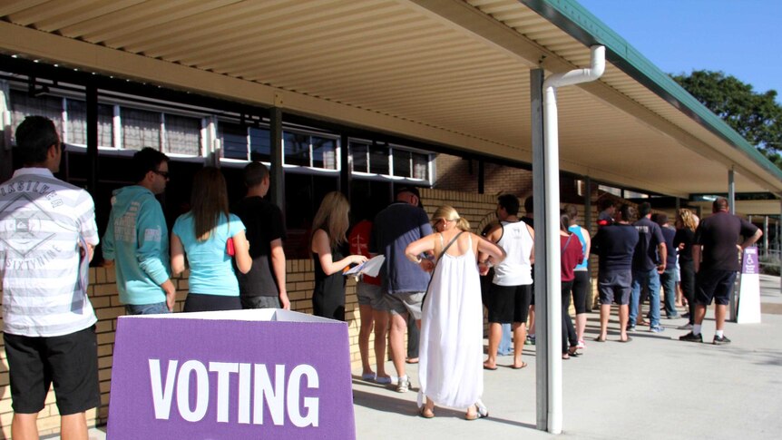 People queue to vote outside a polling station during the federal election