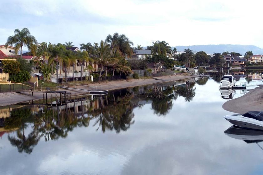 Houses are reflected in a Gold Coast canal